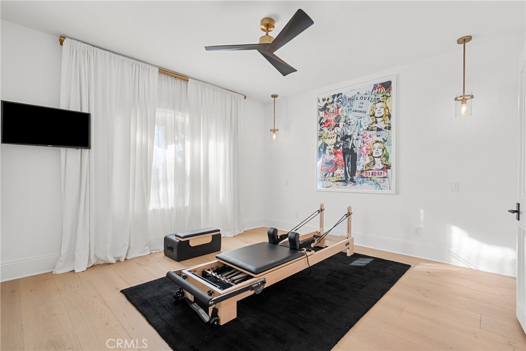 23477 Park Colombo Calabasas, CA 91302 - Photo 42 of 56 a living room with gym equipment and a window
