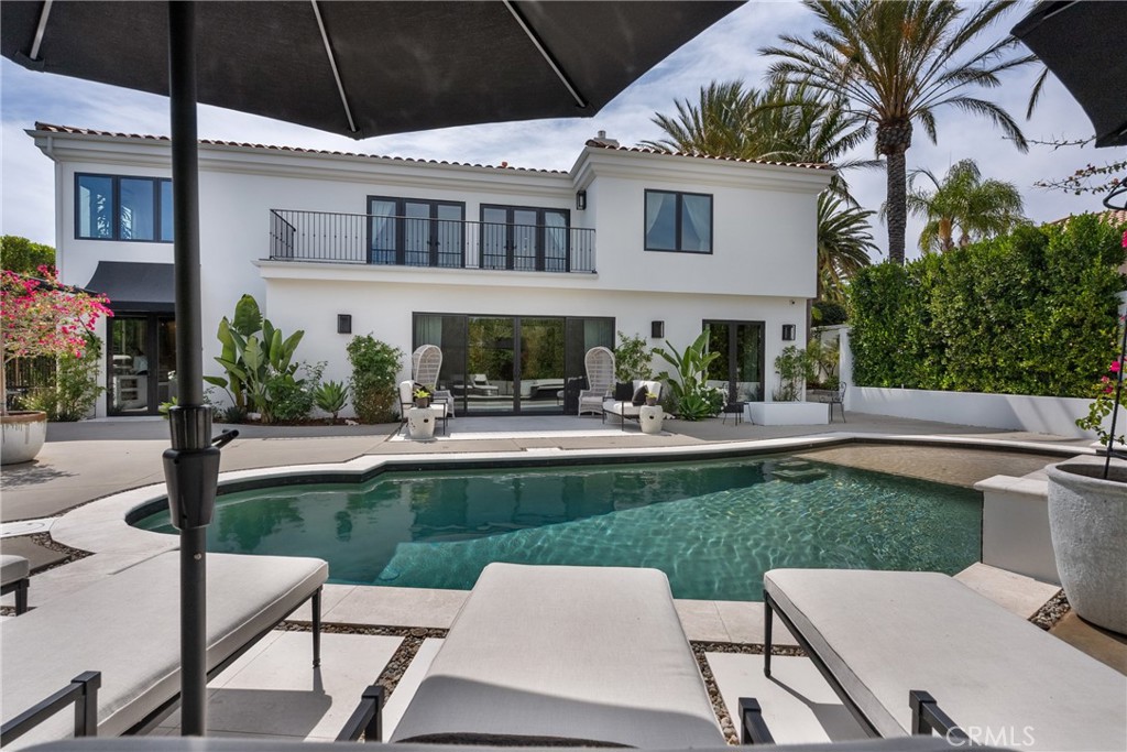 23477 Park Colombo Calabasas, CA 91302 - Photo 44 of 56 a view of a white house with a yard table and chairs