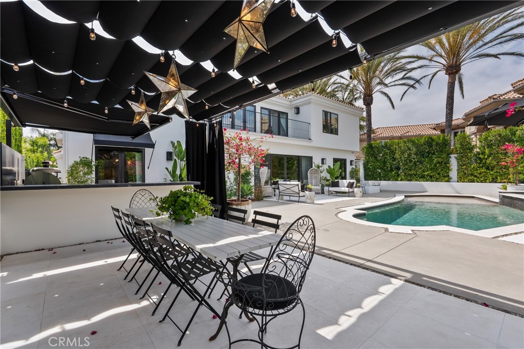 23477 Park Colombo Calabasas, CA 91302 - Photo 46 of 54 a view of a patio with a table and chairs