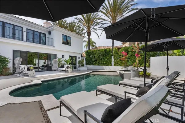 a view of a swimming pool with lounge chairs