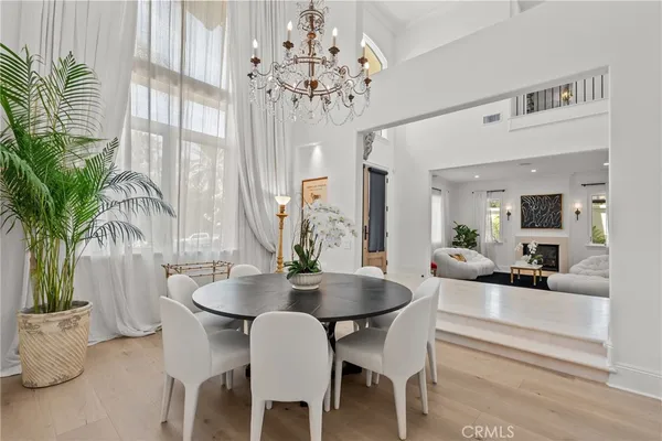 a view of a dining room with furniture and a chandelier