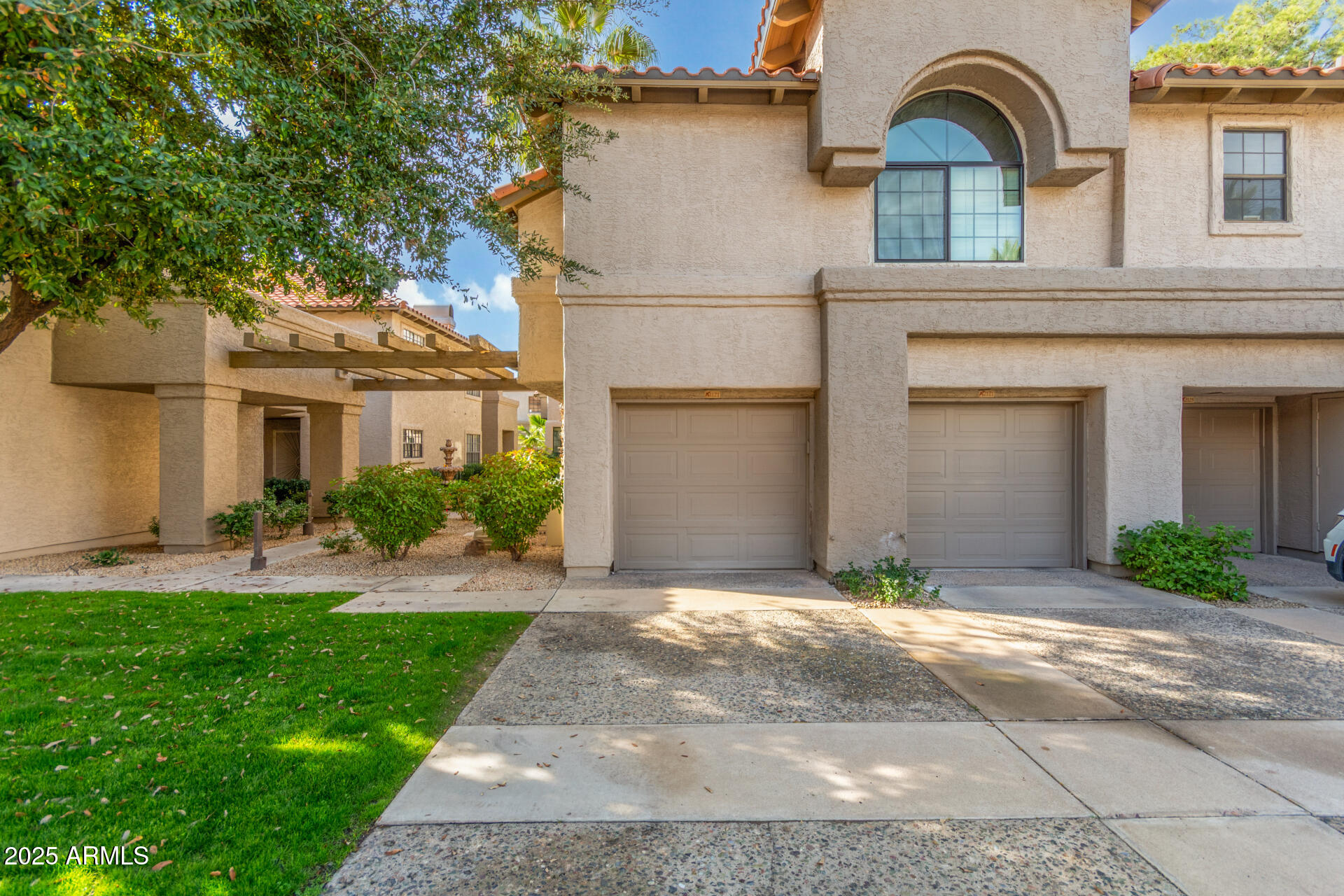 10019 East Mountain View Road, Unit 1121 Scottsdale, AZ 85258 - Photo 1 of 39 a front view of a house with garden