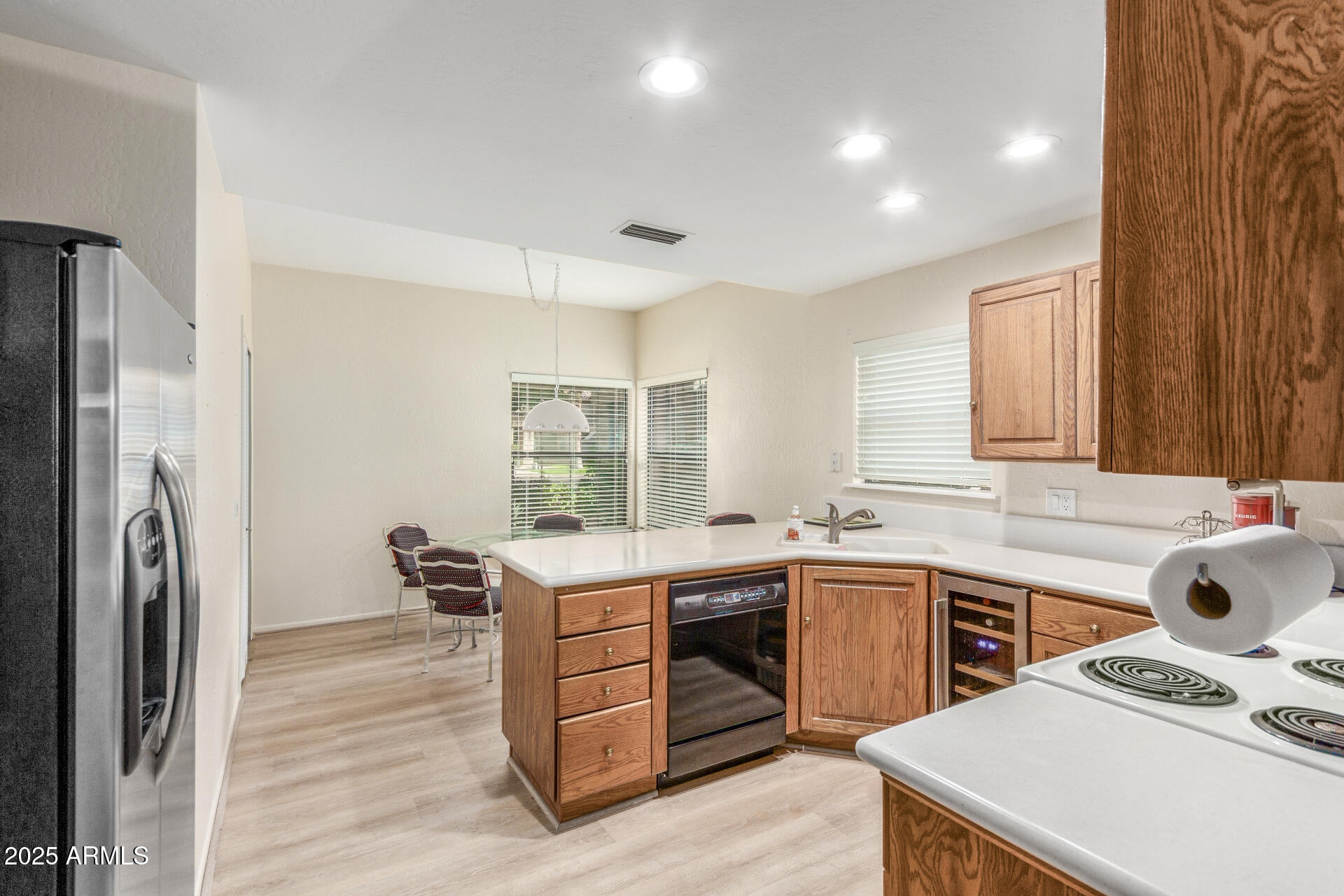 10019 East Mountain View Road, Unit 1121 Scottsdale, AZ 85258 - Photo 10 of 39 a kitchen with a sink a stove a refrigerator cabinets and wooden floor