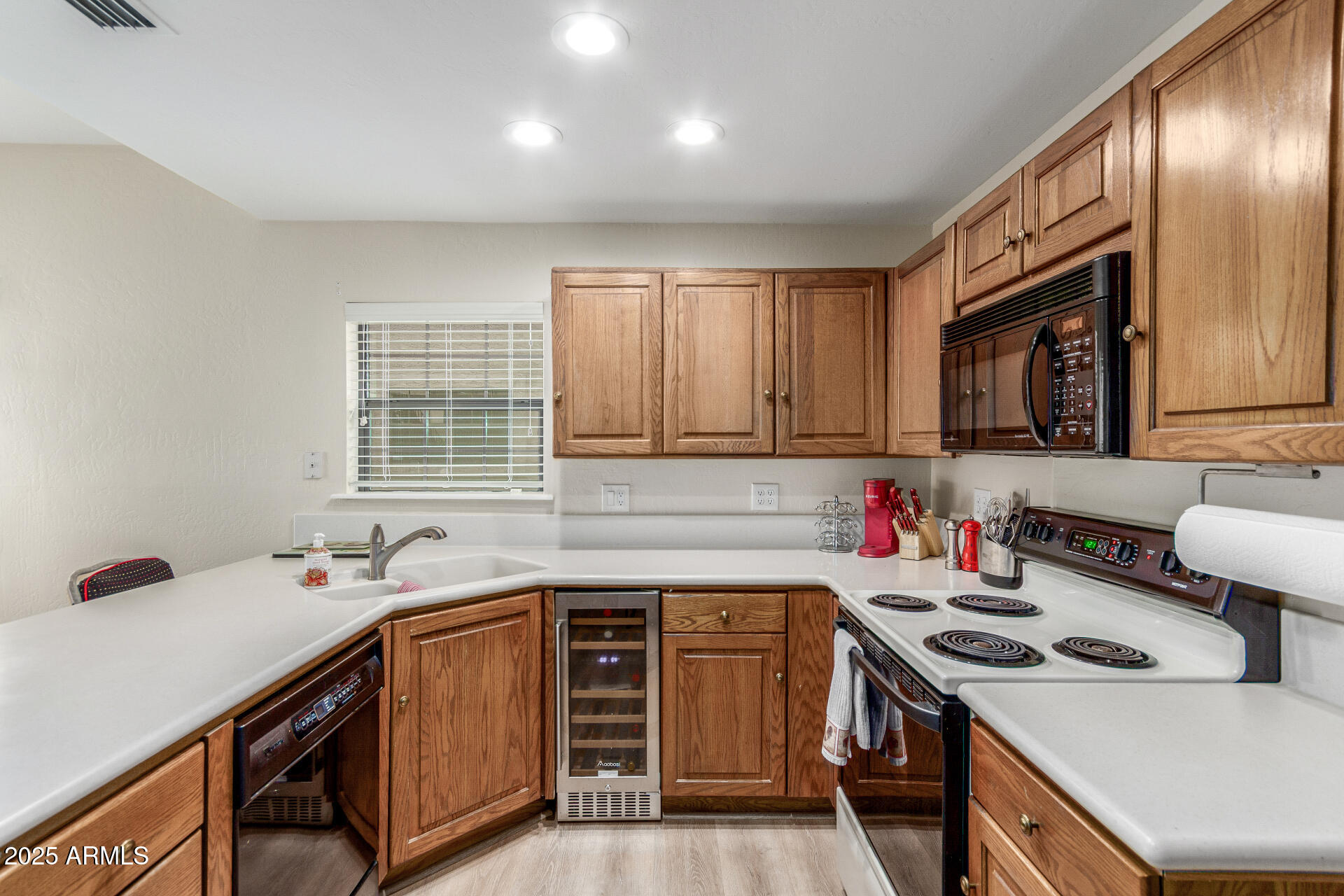 10019 East Mountain View Road, Unit 1121 Scottsdale, AZ 85258 - Photo 11 of 39 a kitchen with a stove sink and cabinets