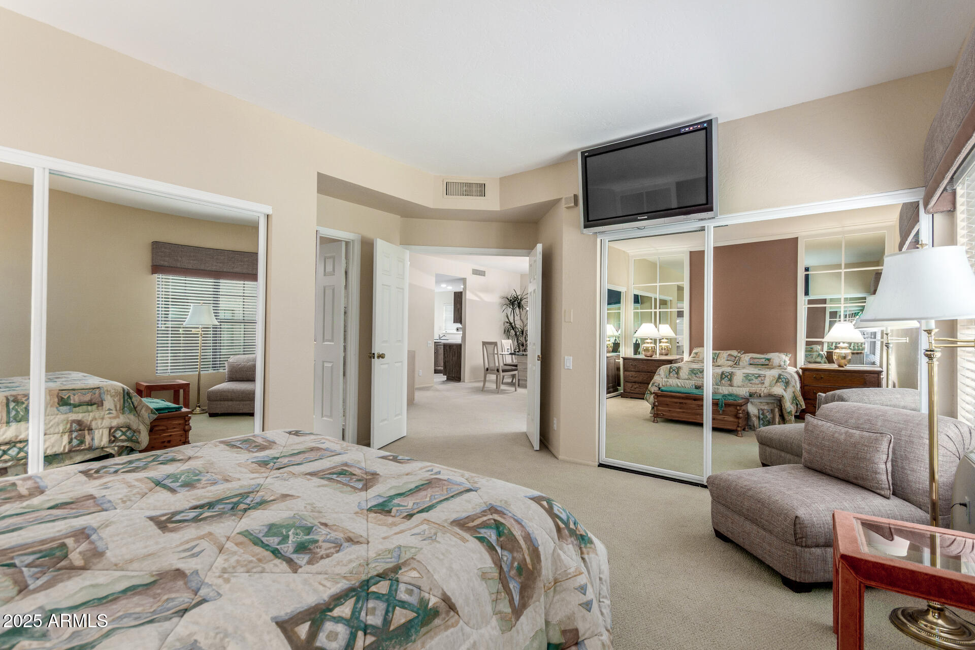 10019 East Mountain View Road, Unit 1121 Scottsdale, AZ 85258 - Photo 14 of 39 a bedroom with a bed a couch and dresser
