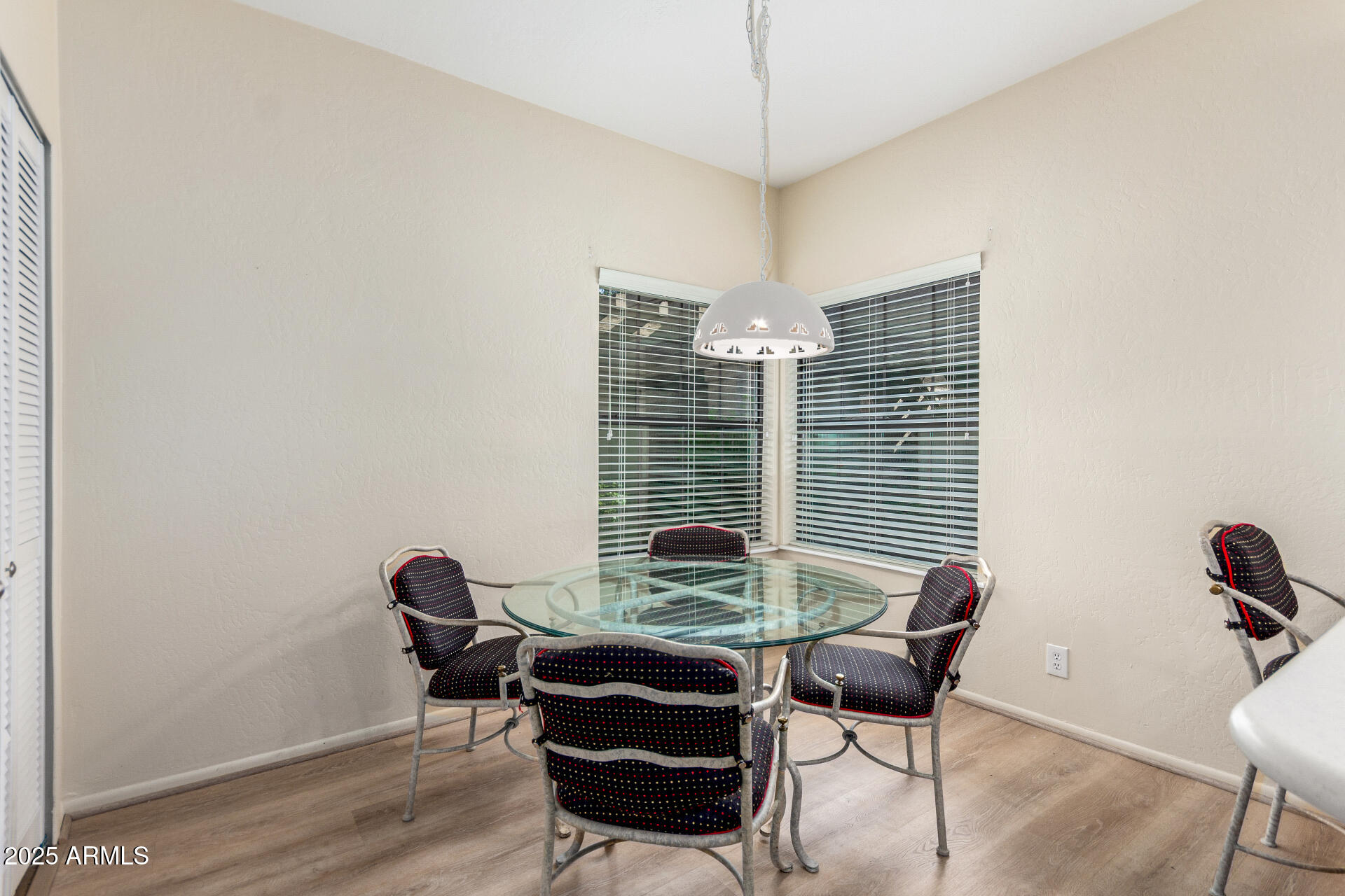 10019 East Mountain View Road, Unit 1121 Scottsdale, AZ 85258 - Photo 22 of 39 a view of a dining room with furniture wooden floor and chandelier