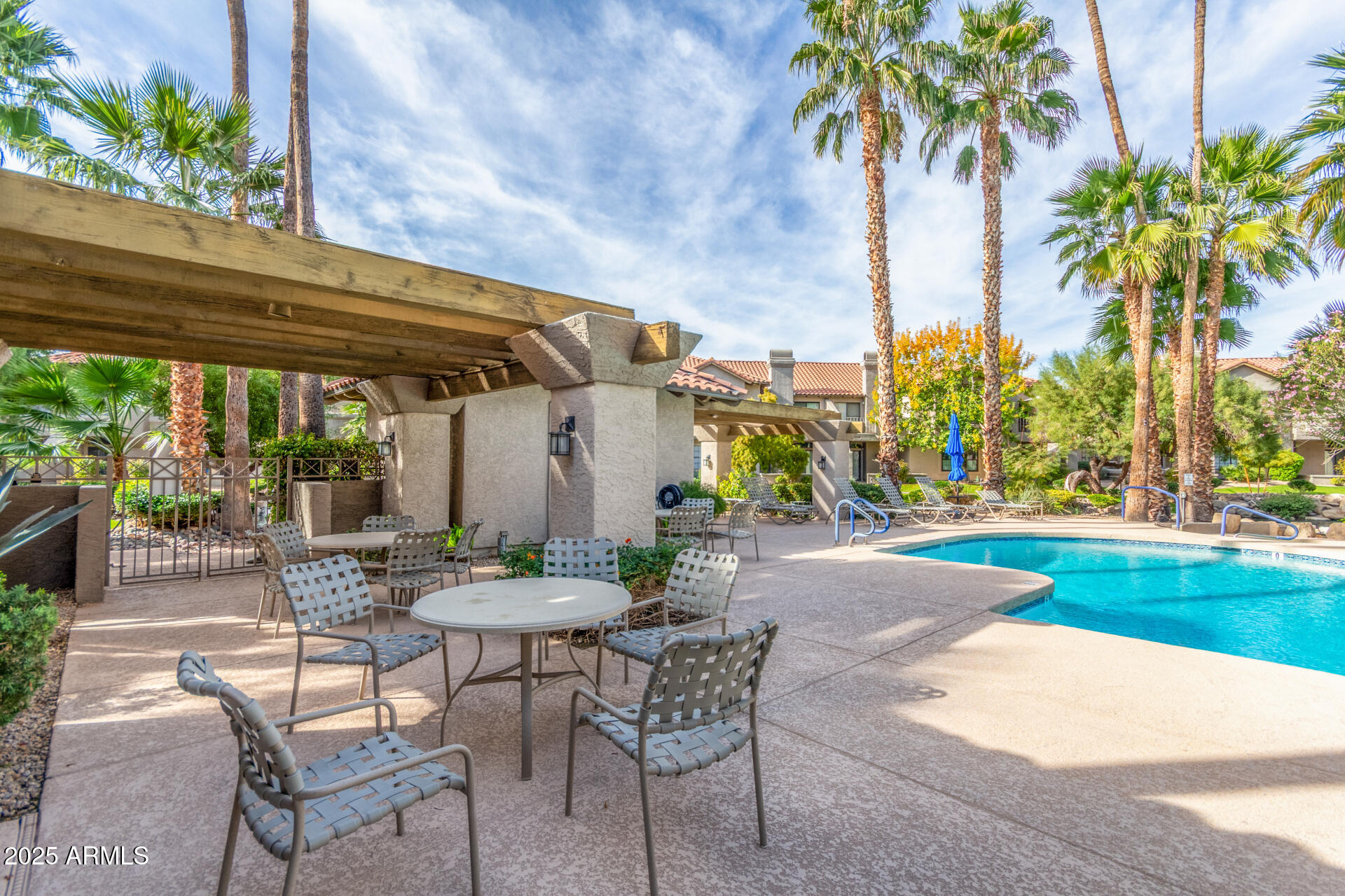 10019 East Mountain View Road, Unit 1121 Scottsdale, AZ 85258 - Photo 34 of 39 a patio with a table and chairs and potted plants