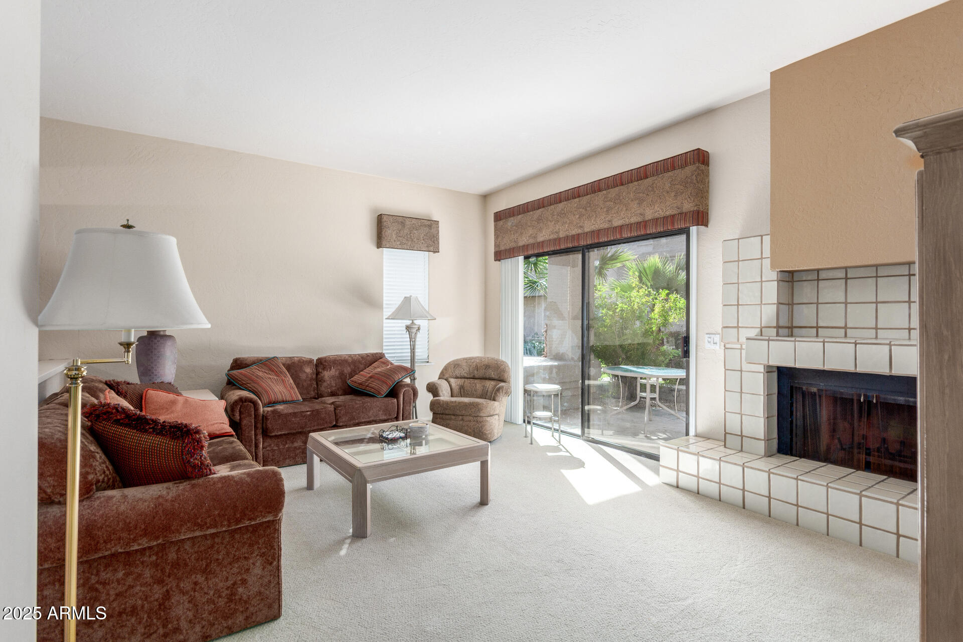 10019 East Mountain View Road, Unit 1121 Scottsdale, AZ 85258 - Photo 8 of 39 a living room with furniture a fireplace and a floor to ceiling window
