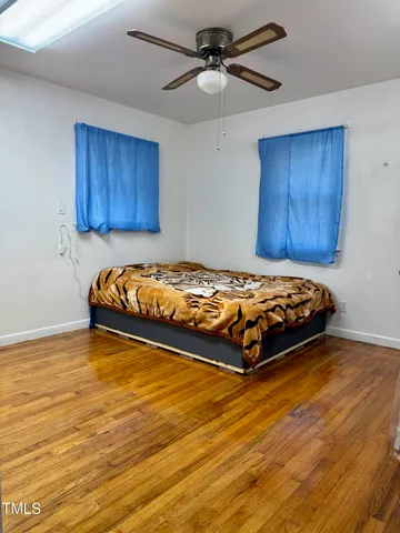a view of an empty room with a ceiling fan and a window