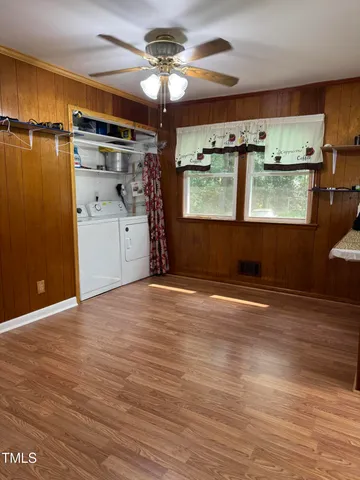 a view of a room with wooden floor