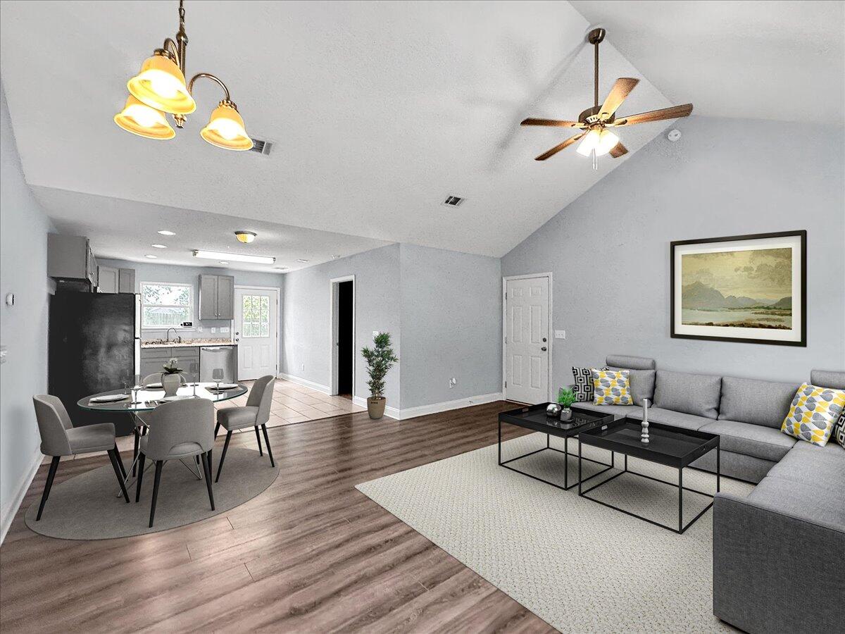a living room with furniture a chandelier and a flat screen tv