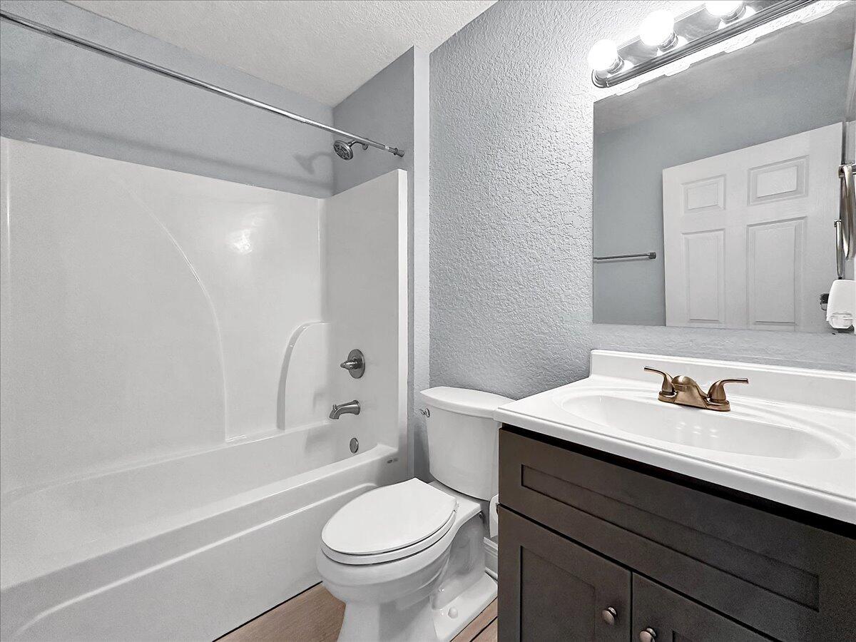 2970 Stillwell Boulevard Crestview, FL 32539 - Photo 11 of 20 a bathroom with a sink toilet vanity and shower