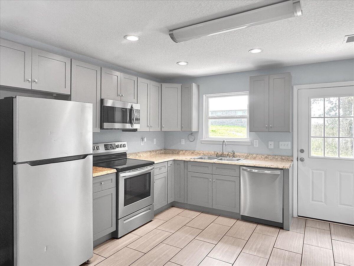 2970 Stillwell Boulevard Crestview, FL 32539 - Photo 5 of 20 a kitchen with appliances a sink and lots of cabinets