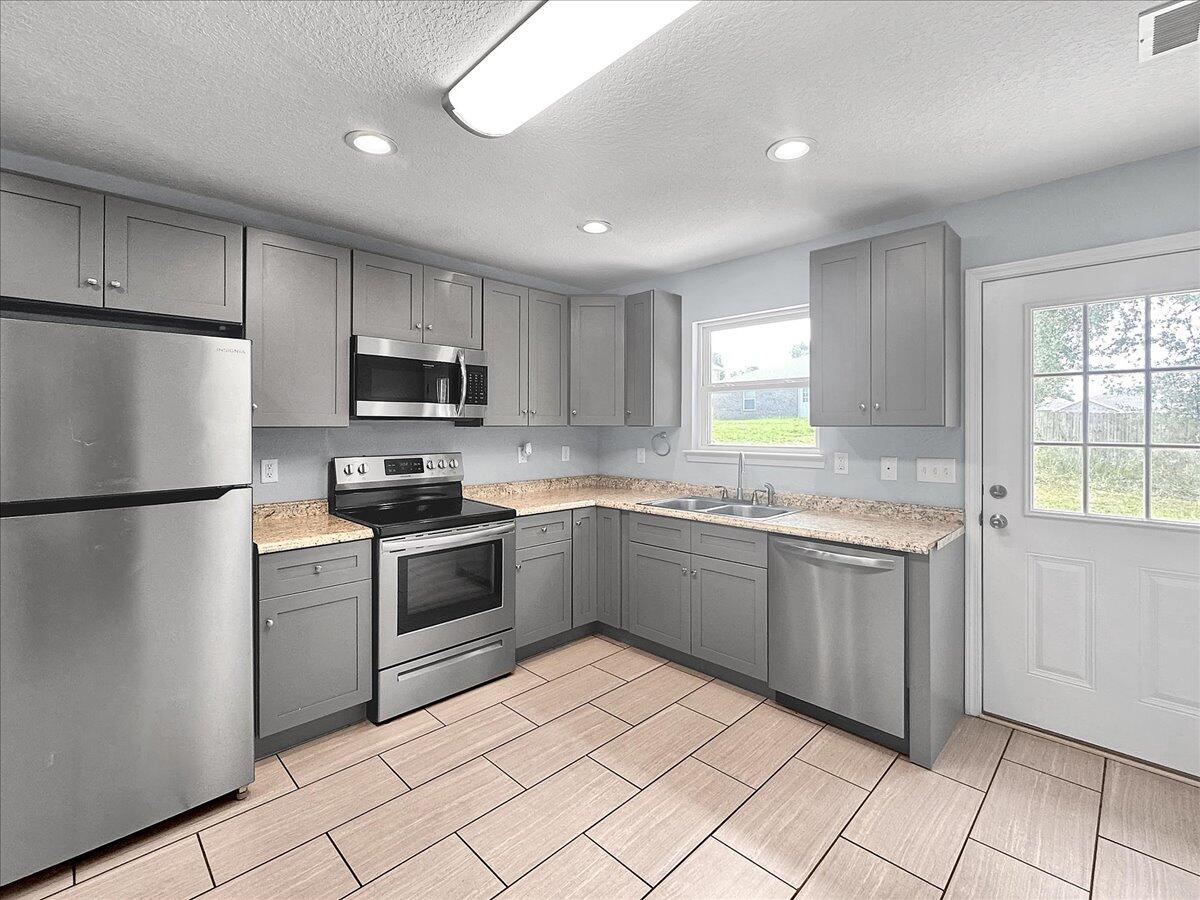 2970 Stillwell Boulevard Crestview, FL 32539 - Photo 6 of 20 a kitchen with granite countertop appliances cabinets and a sink