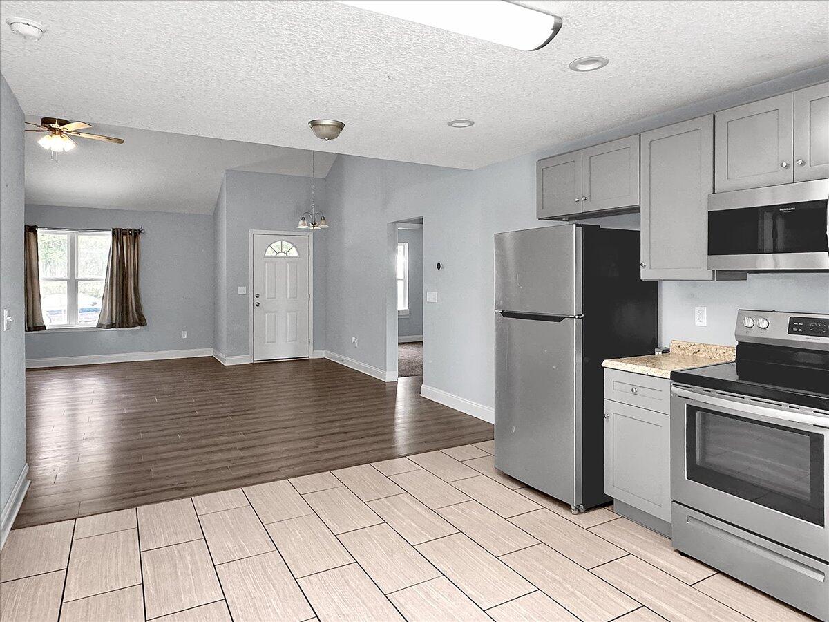 2970 Stillwell Boulevard Crestview, FL 32539 - Photo 8 of 20 a view of a kitchen with a stove cabinets and wooden floor