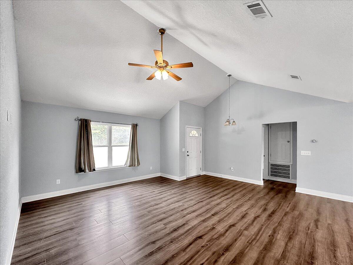 2970 Stillwell Boulevard Crestview, FL 32539 - Photo 10 of 20 an empty room with wooden floor and windows