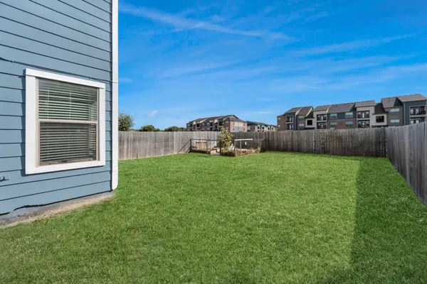 a front view of a house with a garden and yard