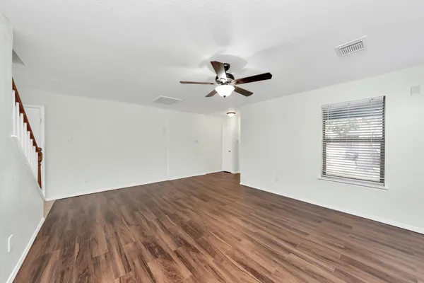 wooden floor in an empty room with a window