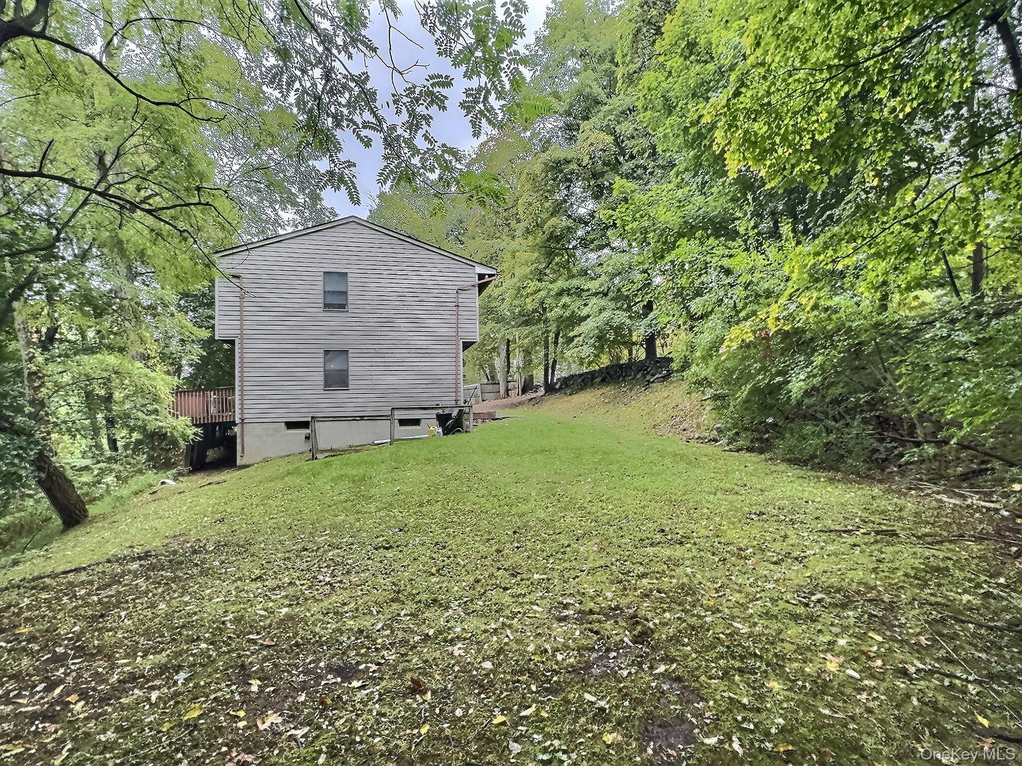 28 Wilson Place Cornwall, NY 12518 - Photo 23 of 24 a backyard of a house with plants and large tree