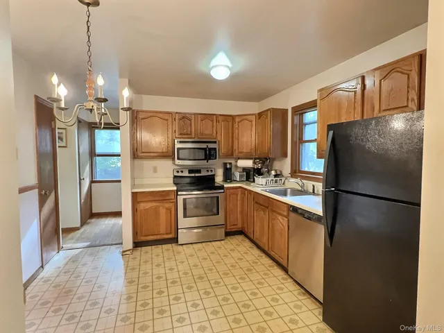 a kitchen with granite countertop a refrigerator and a sink