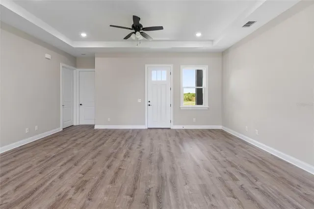 a view of kitchen with granite countertop cabinets wooden floor and a sink
