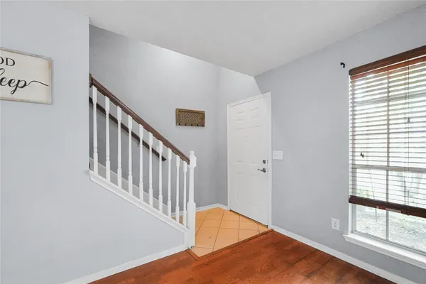 a view of a hallway with bedroom and wooden floor