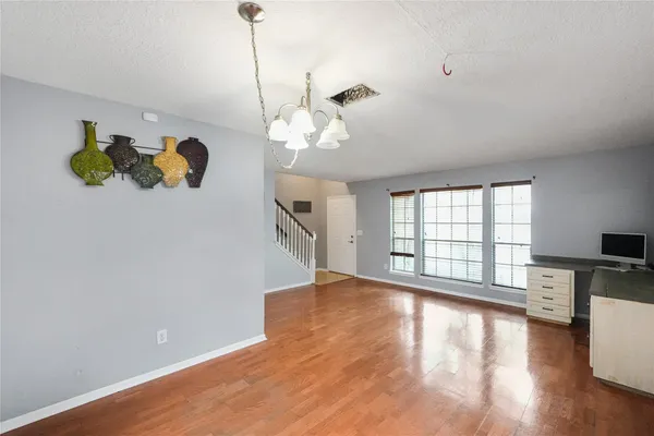 a bedroom with a bed and a view of kitchen