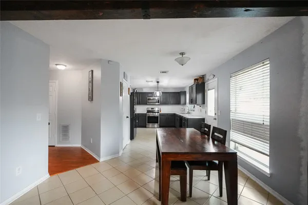 a living room with furniture a flat screen tv and a floor to ceiling window