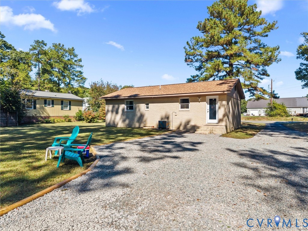 408 Howerton Road Tappahannock, VA 22560 - Photo 44 of 49 Gravel driveway with a manicured lawn, featuring a