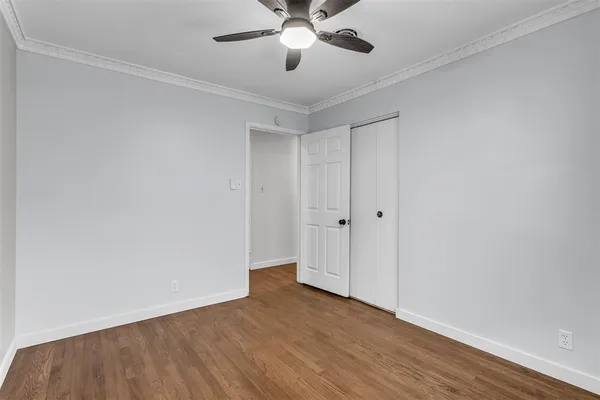 a view of an empty room and wooden floor