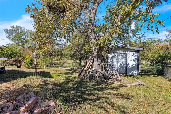a view of a yard with large trees