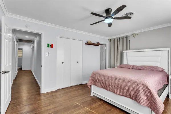 a bedroom with a bed and a ceiling fan