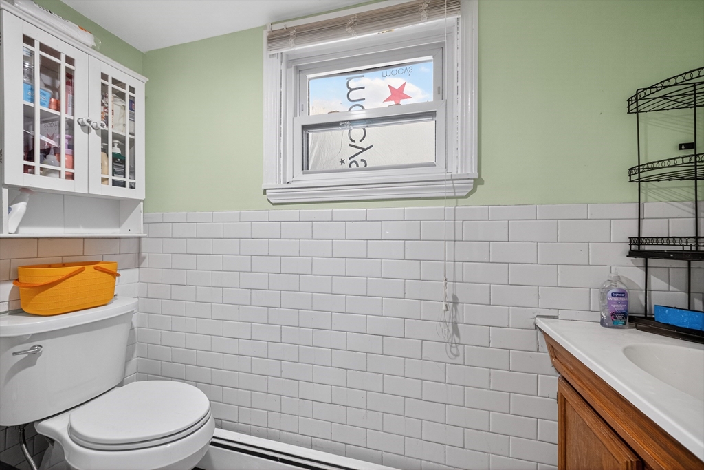 5 South Webster Street Haverhill, MA 01835 - Photo 11 of 15 a bathroom with a sink a toilet and a mirror