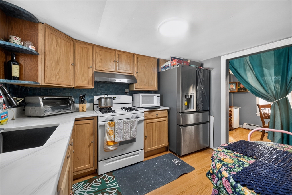 5 South Webster Street Haverhill, MA 01835 - Photo 7 of 15 a kitchen with stainless steel appliances granite countertop a refrigerator a stove and a sink