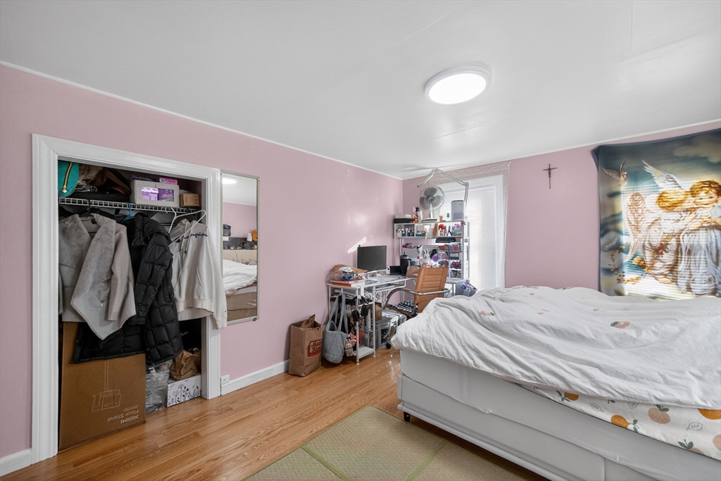 5 South Webster Street Haverhill, MA 01835 - Photo 9 of 15 a bedroom with a bed and a walk in closet