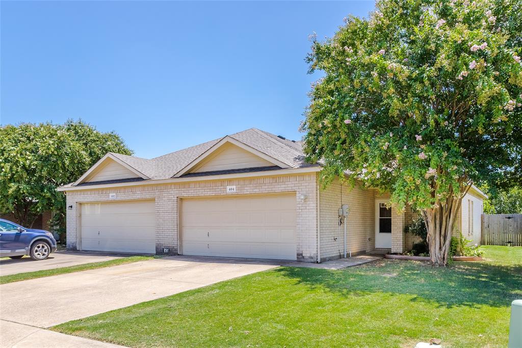 Single story home featuring brick siding, roof with shingles, concrete driveway, and a garage