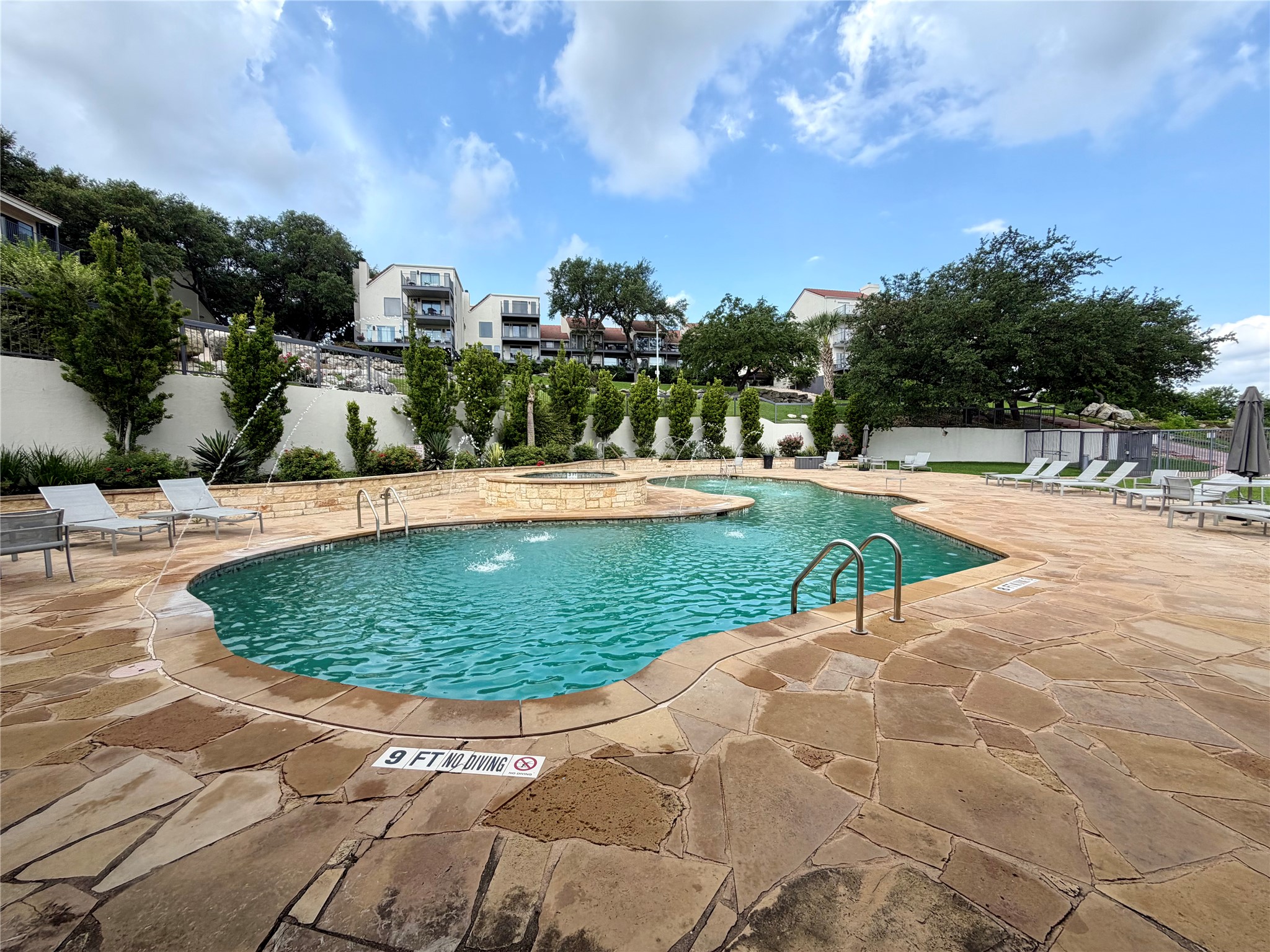 2918 Ranch Road 620 North, Unit C120 Austin, TX 78734 - Photo 28 of 34 A closer view of the resort-style pool with fountains and a surrounding stone deck offers a refreshing escape.
