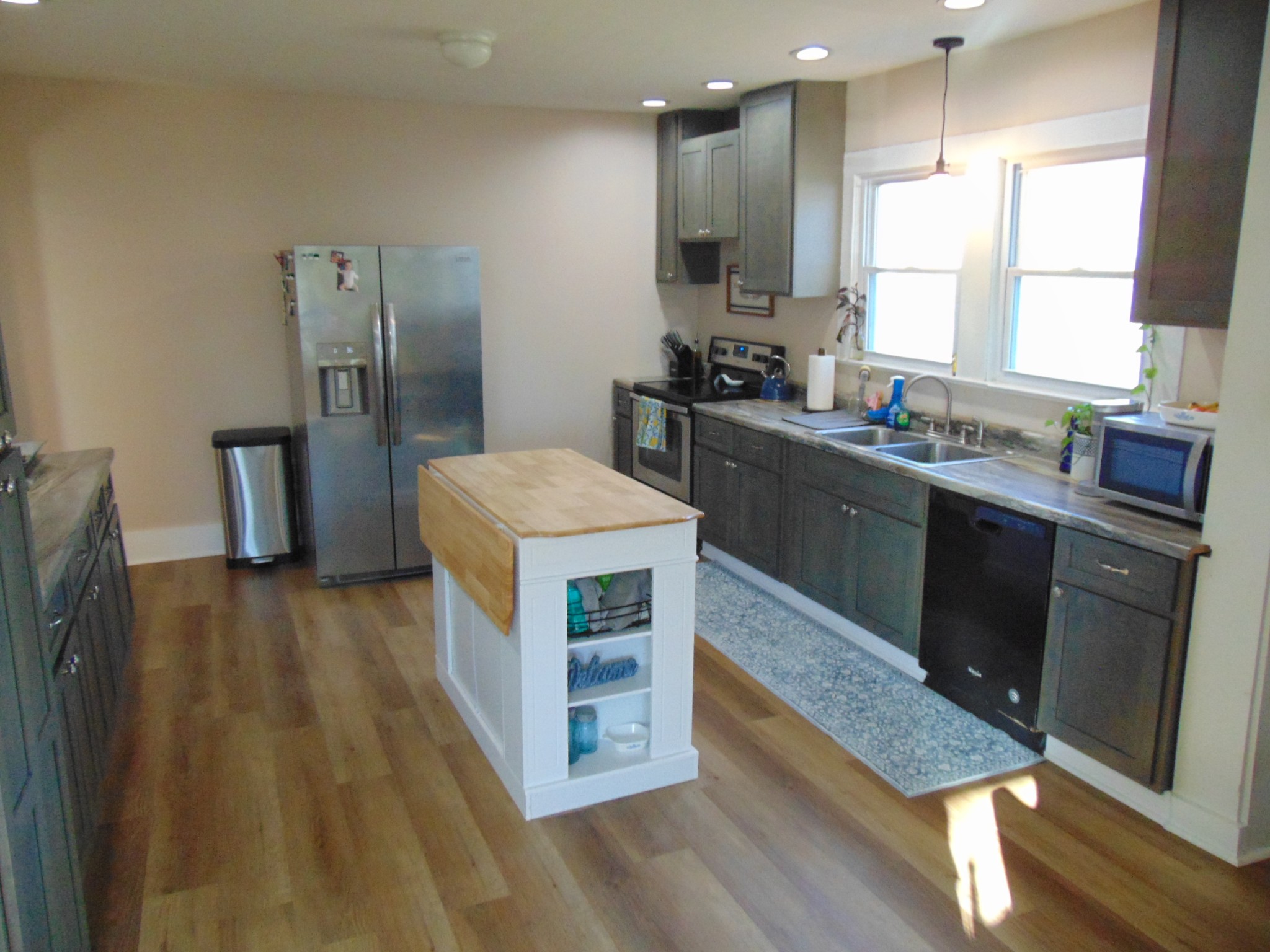 3547 Coffey Branch Road Cornersville, TN 37047 - Photo 15 of 57 a kitchen with stainless steel appliances a kitchen island hardwood floor sink and a window