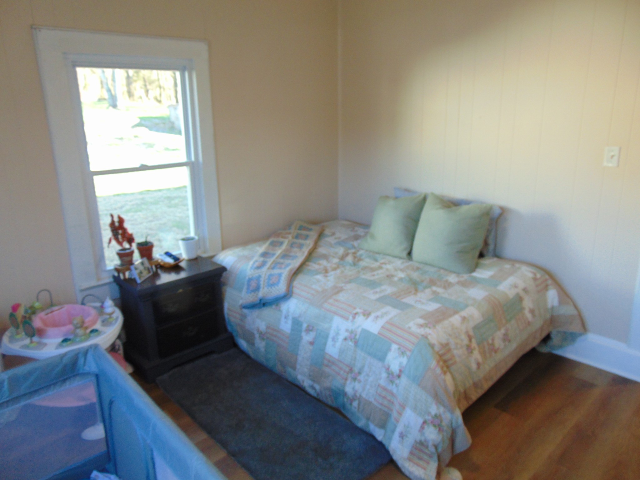 3547 Coffey Branch Road Cornersville, TN 37047 - Photo 21 of 57 a bed sitting in a bedroom next to a window