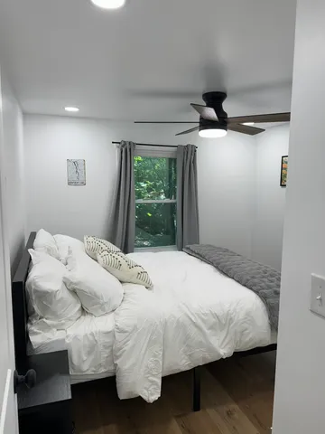 a bedroom with a bed and a window