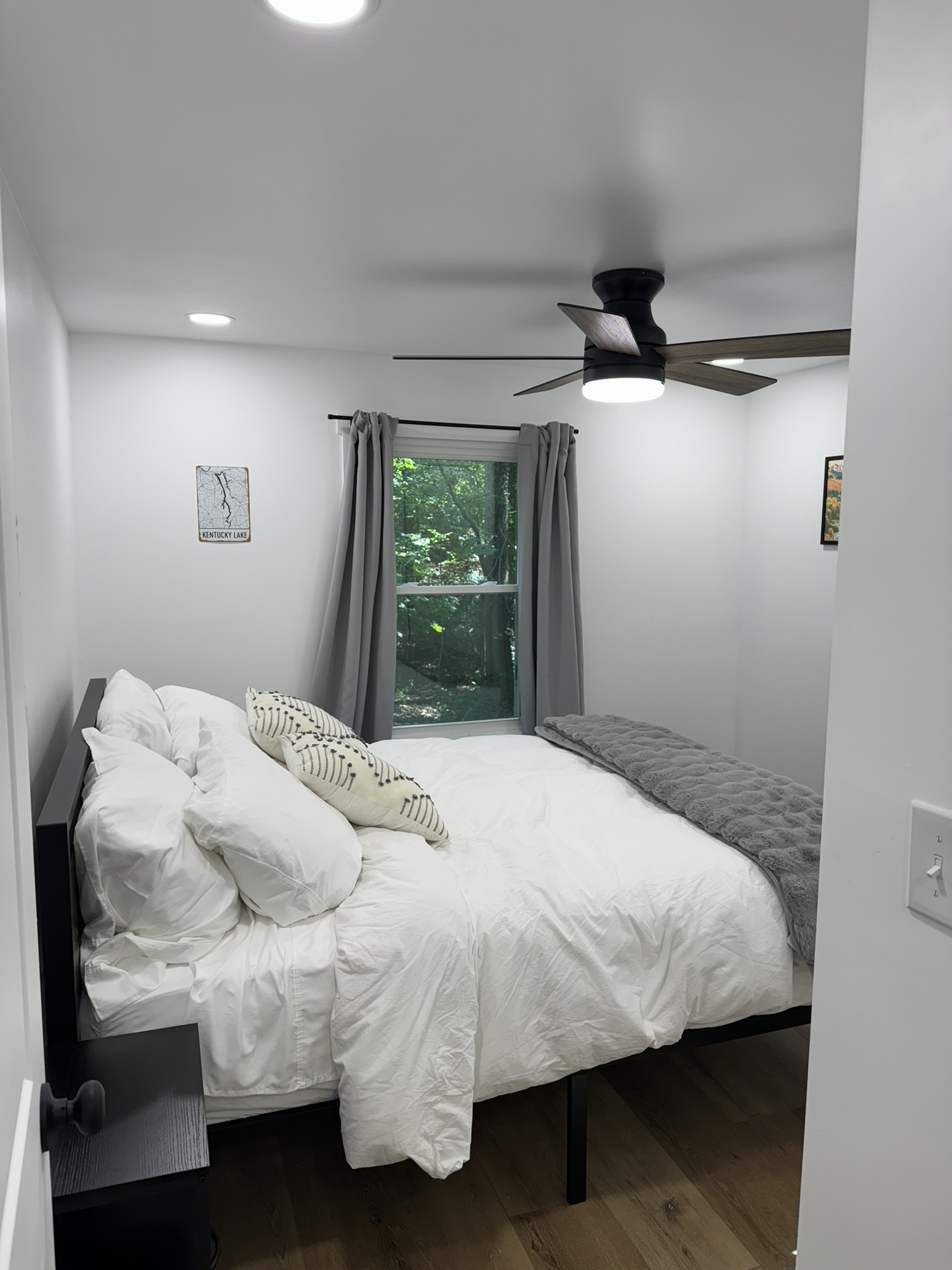 710 3rd Street Paris, TN 38242 - Photo 13 of 34 a bed sitting in a bedroom next to a window