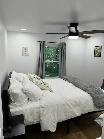 a bedroom with a bed and a window