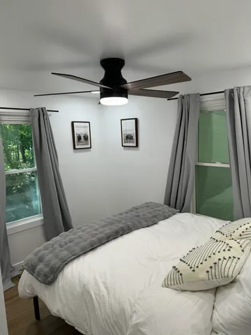 a bedroom with a bed and a window