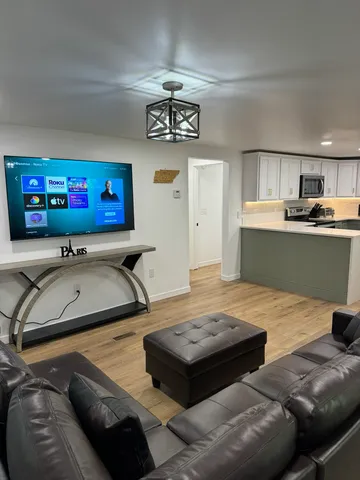 a living room with furniture and flat screen tv