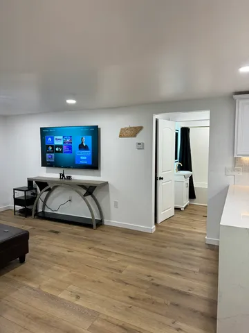 a kitchen with stainless steel appliances granite countertop a table chairs and a refrigerator