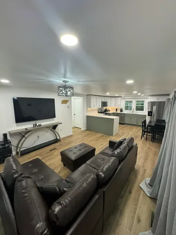 a large kitchen with a large counter top stainless steel appliances and cabinets