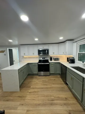 a kitchen with granite countertop a stove and a microwave