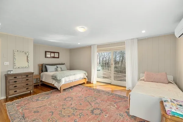 a bedroom with a large bed and a window