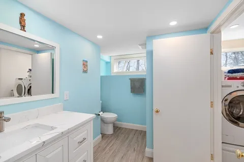 a spacious bathroom with a toilet sink and mirror