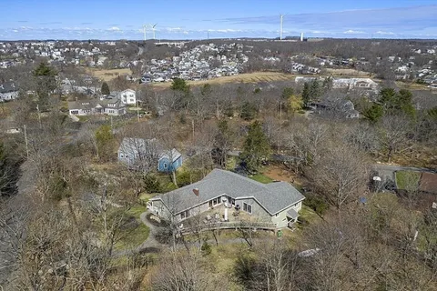 an aerial view of a houses with a yard